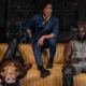 Danielle Pineda's Faye Valentine, John Cho's Spike Spiegel, and Mustafa Shakir's Jet Black lounge on the couch in the Bebop's living room.